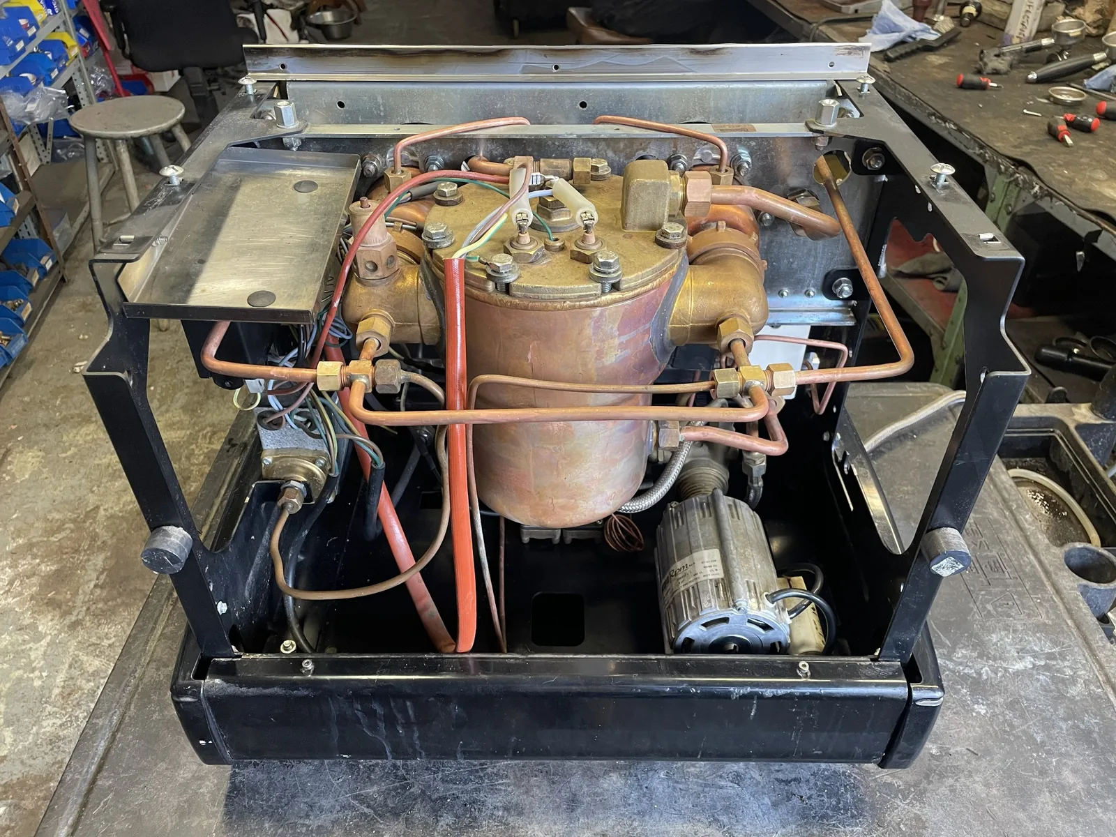 Scaled espresso machine boiler beside a new copper replacement