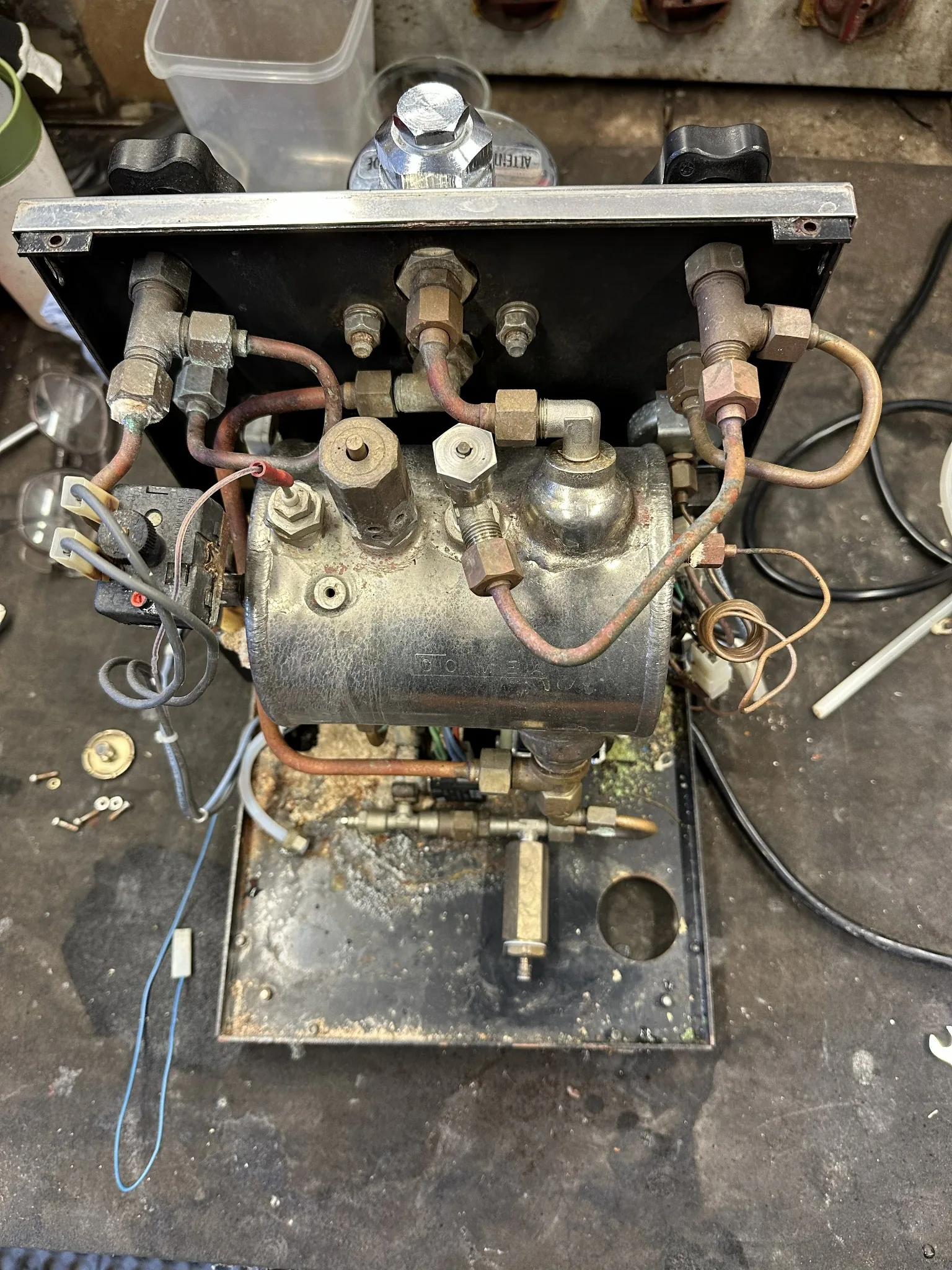 Two vintage lever espresso machines in the workshop